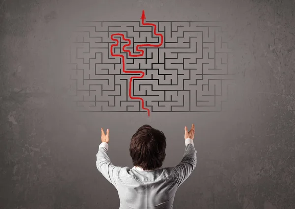 Business man looking at a maze and the way out — Stock Photo, Image