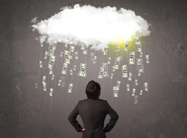 Business man in suit looking at cloud with falling money — Stock Photo, Image