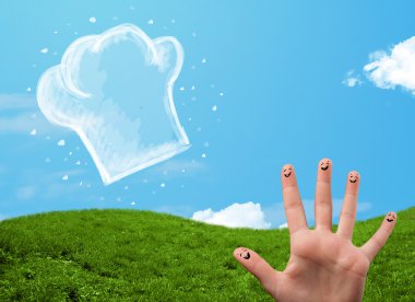 Mutlu gülen yüzlü parmaklar aşçı şapkasının resmine bakıyor.