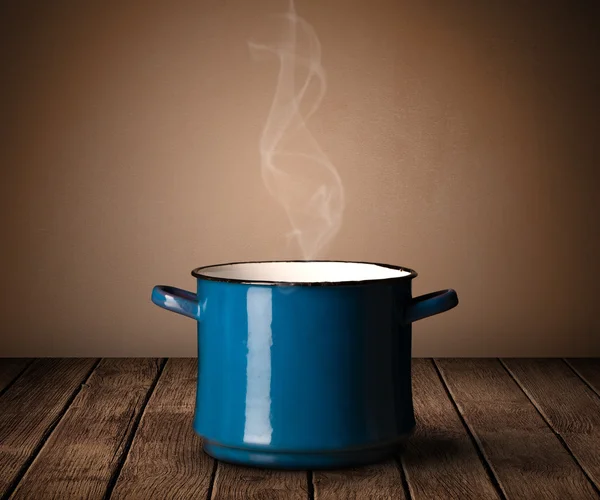 Pot on old wooden table — Stock Photo, Image