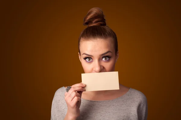 Cute girl holding white card at front of her lips with copy spac — Stock Photo, Image