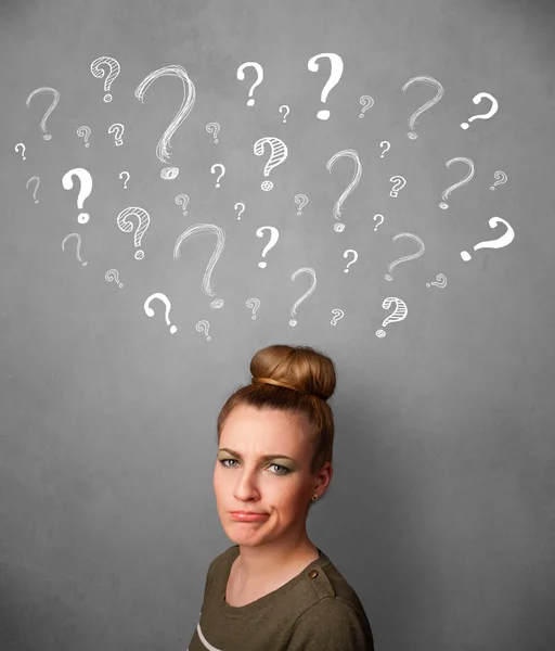 Young woman with question marks above her head — Stock Photo, Image