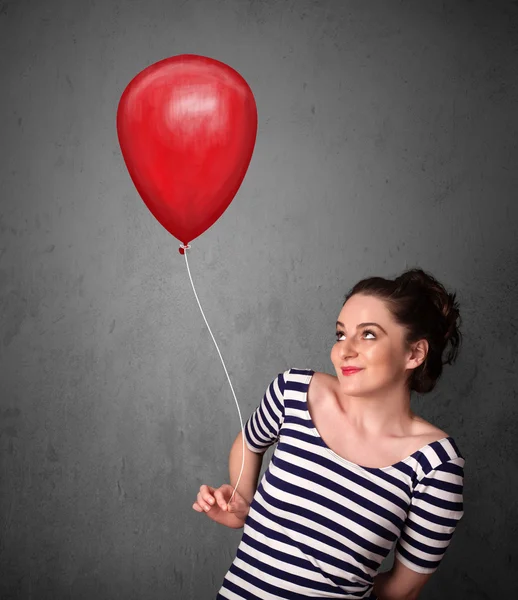 Kvinna som håller en röd ballong — Stockfoto