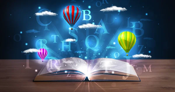 Open book with glowing fantasy abstract clouds and balloons — Stock Photo, Image