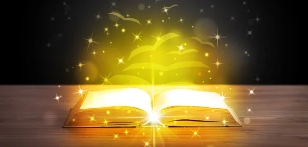 Open book with golden glow flying paper pages — Stock Photo, Image