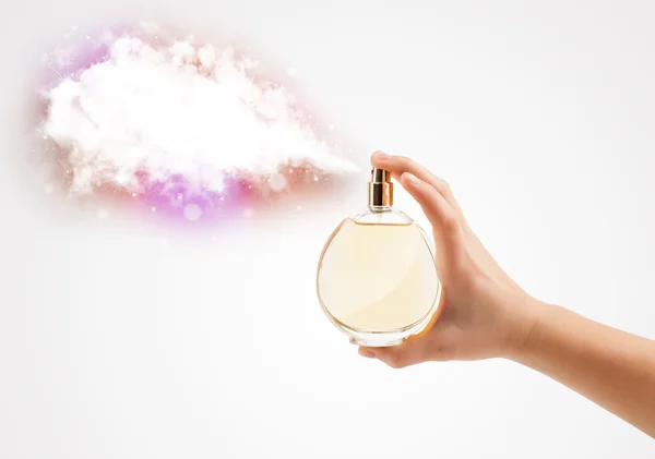 Woman hands spraying colorful cloud — Stock Photo, Image