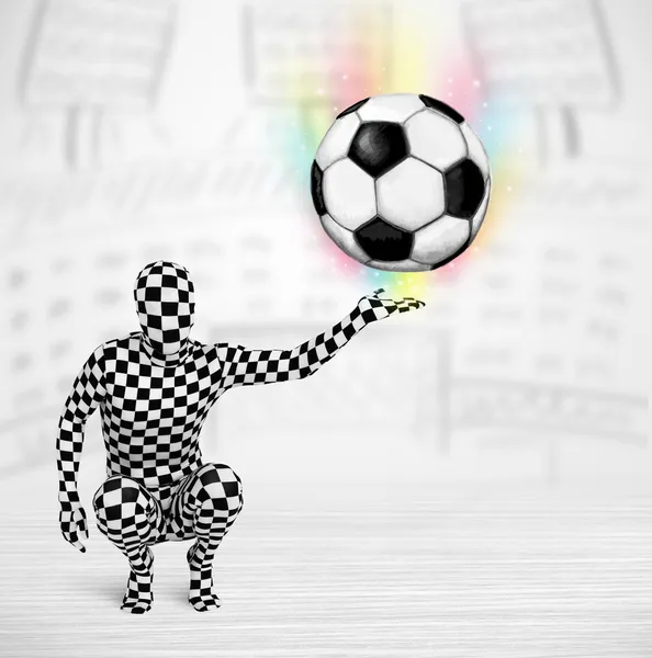 Man in full body suit holdig soccer ball — Stock Photo, Image