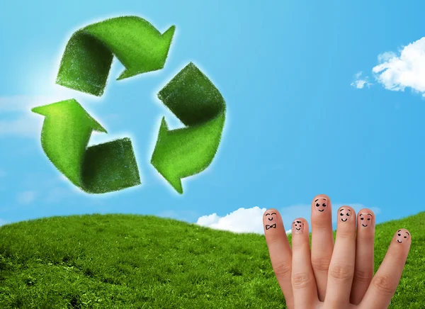 Happy smiley fingers looking at green leaf recycle sign — Stock Photo, Image