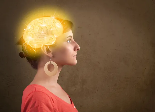 Young girl thinking with glowing brain illustration — Stock Photo, Image