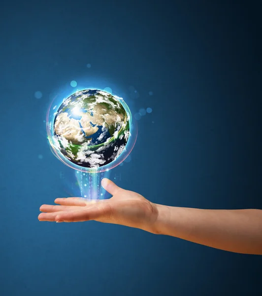 Woman holding a glowing earth globe — Stock Photo, Image
