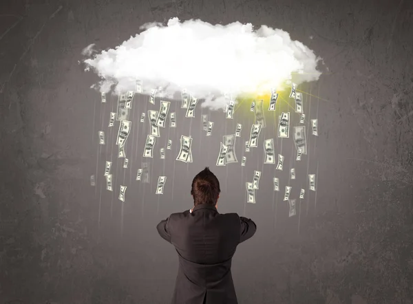 Business man in suit looking at cloud with falling money — Stock Photo, Image