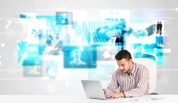 Business person at desk with modern tech images at background — Stock Photo, Image