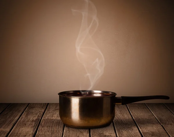 Pot on old wooden table — Stock Photo, Image