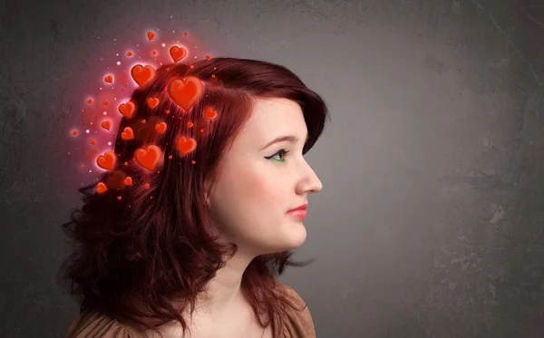 Young person thinking about love with red hearts — Stock Photo, Image