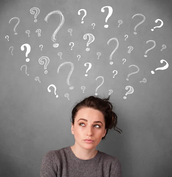 Young woman with question marks above her head — Stock Photo, Image