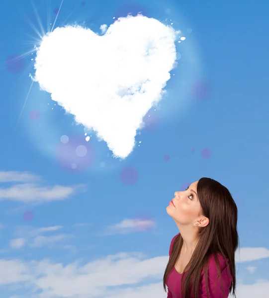Ładny dziewczyna patrząc na chmurze białe serca na błękitne niebo — Zdjęcie stockowe
