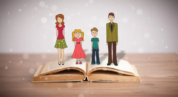 Kresba šťastné rodiny na otevřené knize — Stock fotografie