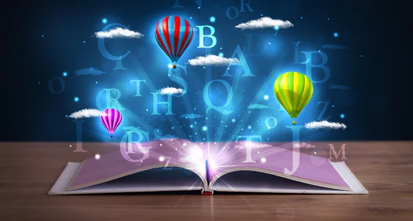 Open book with glowing fantasy abstract clouds and balloons — Stock Photo, Image