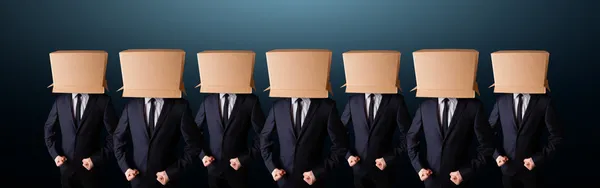 People gesturing with empty box on their head — Stock Photo, Image