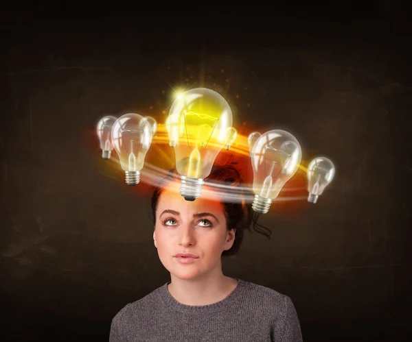 Woman with light bulbs circleing around her head — Stock Photo, Image