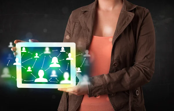 Young person presenting tablet with green social media icons — Stock Photo, Image
