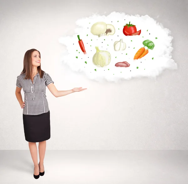 Young girl presenting nutritional cloud with vegetables — Stock Photo, Image