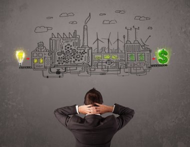 İşadamı fikirlerden para kazanan bir fabrikaya bakıyor.