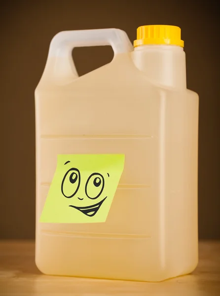 Post-it note with smiley face sticked on gallon