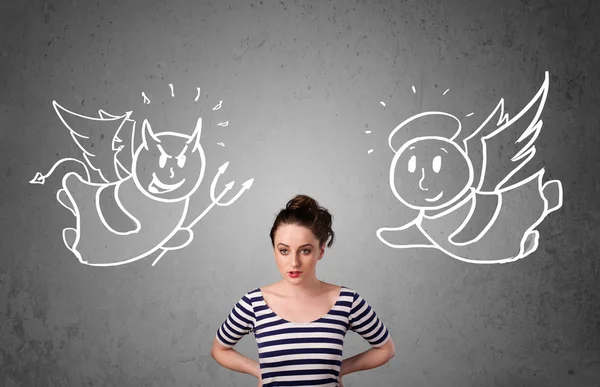 Woman standing between the angel and the devil — Stock Photo, Image