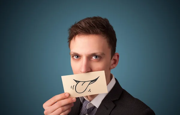 Happy businessman holding funny white card on his mouth — Stock Photo, Image