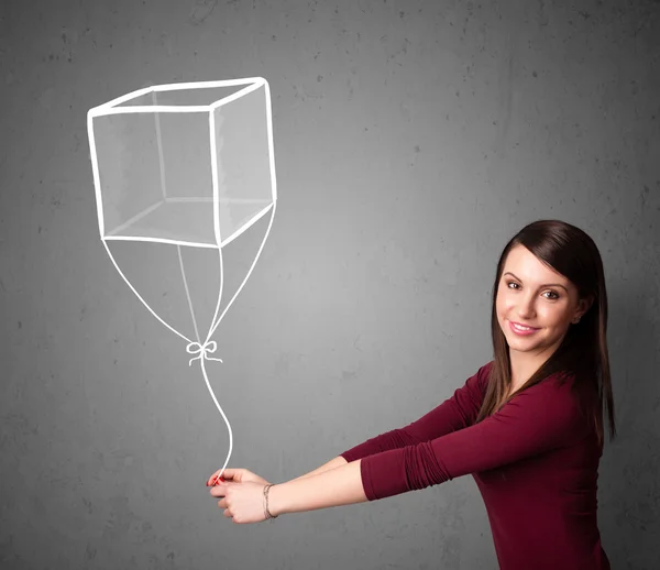 Vrouw met een kubus ballon — Stockfoto