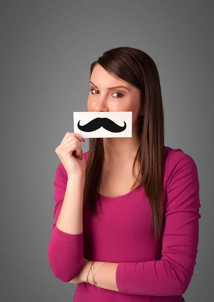 Feliz linda chica sosteniendo papel con bigote dibujo —  Fotos de Stock