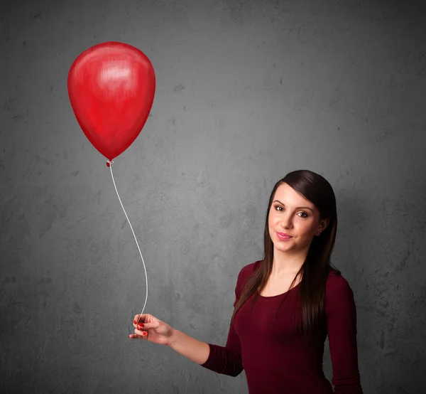 Mujer sosteniendo un globo rojo —  Fotos de Stock