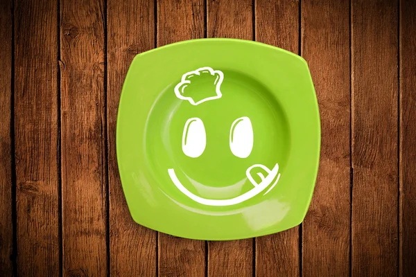 Happy smiley visage de dessin animé sur plaque de plat coloré — Photo