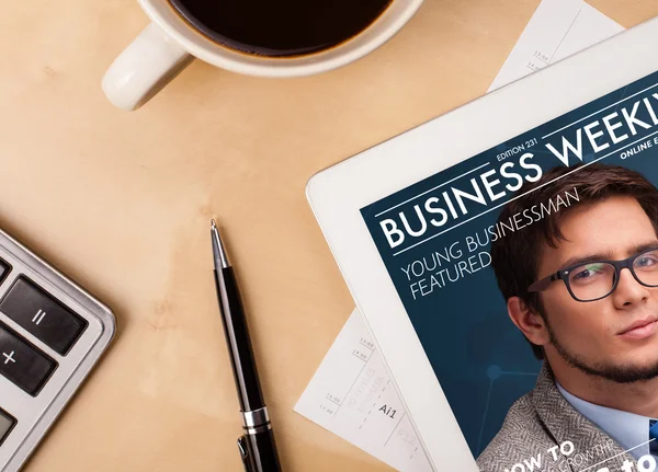 Tablet pc tijdschrift tonen op het scherm met een kopje koffie op een d — Stockfoto