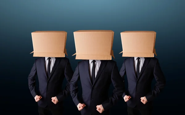 People gesturing with empty box on their head — Stock Photo, Image