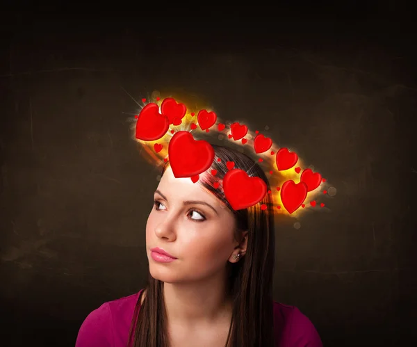 Teenager girl with heart illustrations circleing around her head — Stock Photo, Image