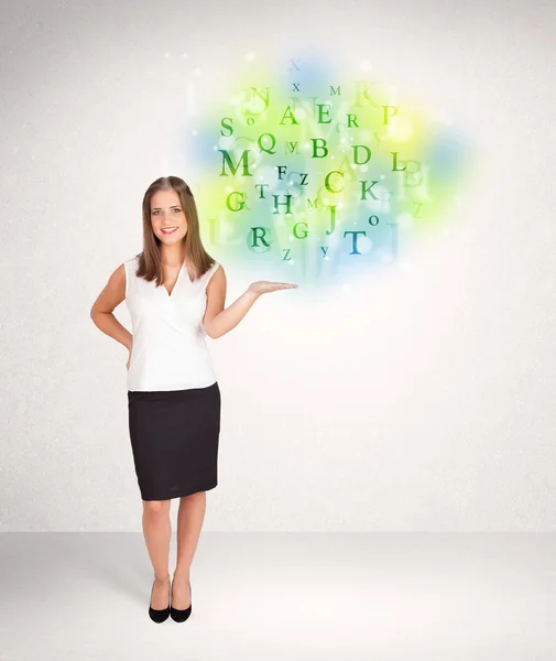 Business women with glowing letter concept — Stock Photo, Image