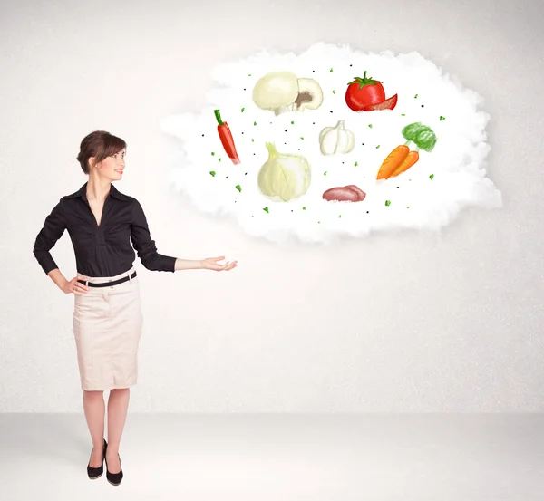 Young girl presenting nutritional cloud with vegetables — Stock Photo, Image