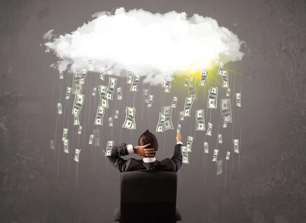 Business man in suit looking at cloud with falling money — Stock Photo, Image