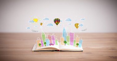 Açık kitap üzerine şehir manzarası çizimi
