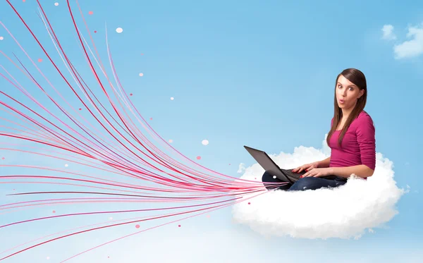 Young woman sitting in cloud with laptop — Stock Photo, Image