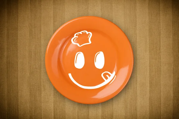 Happy smiley cartoon face on colorful dish plate — Stock Photo, Image