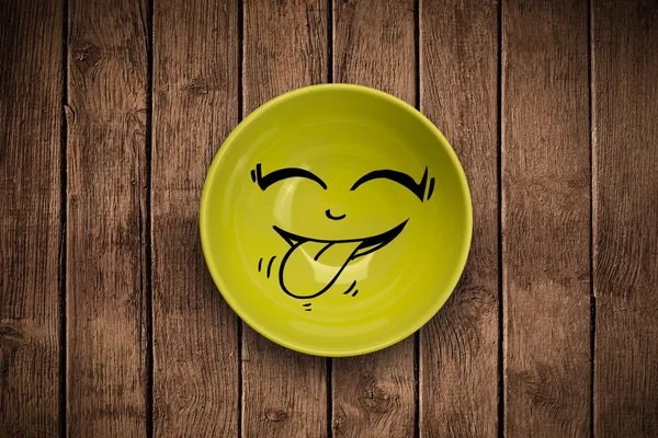 Happy smiley cartoon face on colorful dish plate — Stock Photo, Image