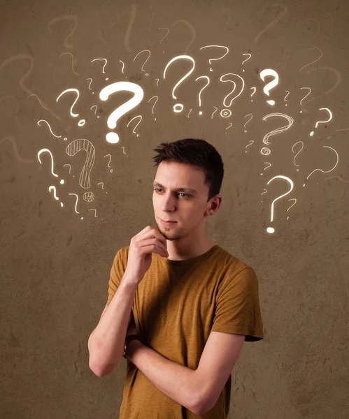 Man with question mark symbols around his head — Stock Photo, Image