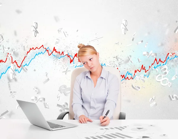 Business woman sitting at table with stock market graph — Stock Photo, Image