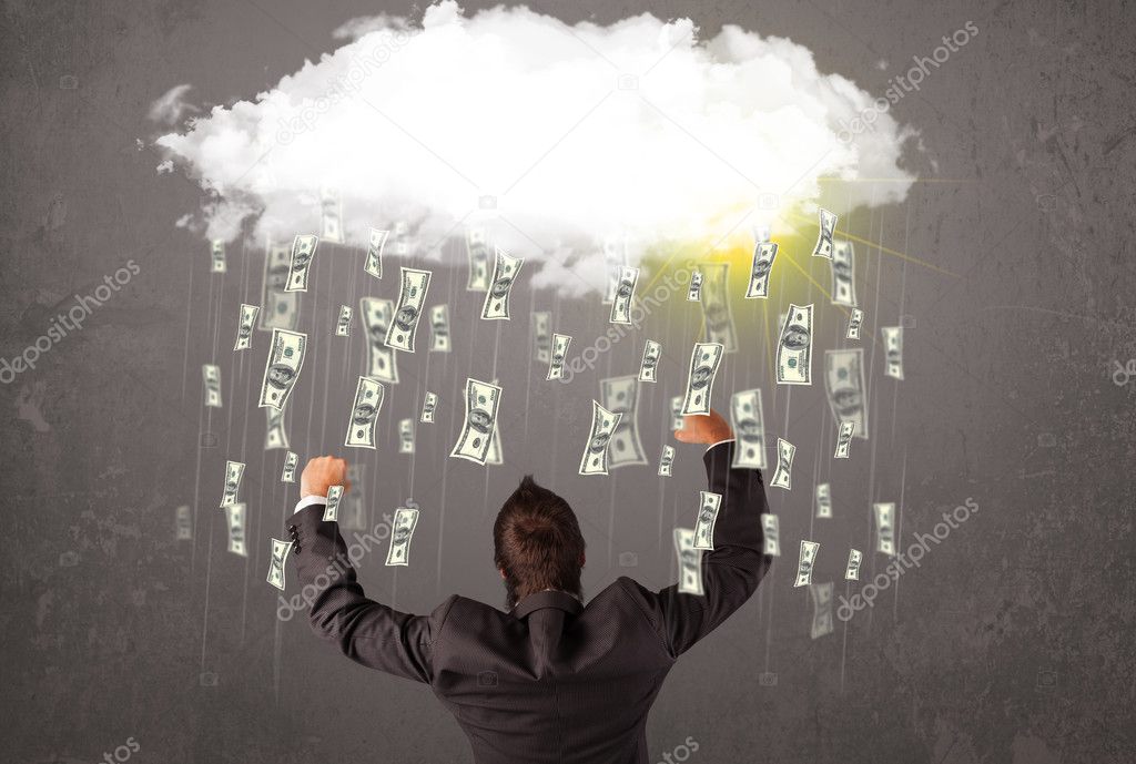 Business man in suit looking at cloud with falling money