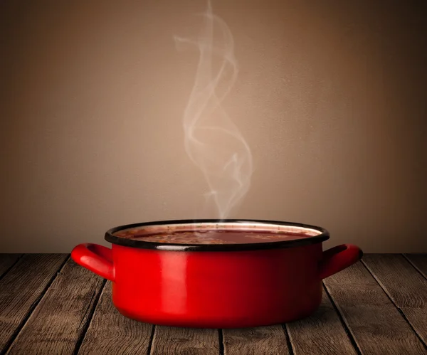 Pot on old wooden table — Stock Photo, Image