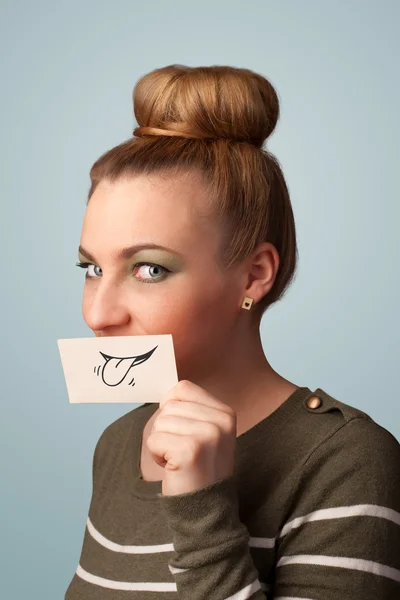 Pretty young girl holding white card with smile drawing — Stock Photo, Image