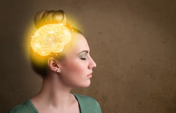 Young girl thinking with glowing brain illustration — Stock Photo, Image